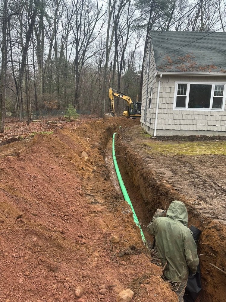 Sewer line excavation trench with new pipe