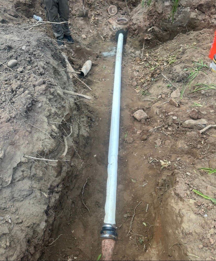New PVC water line pipe laid in excavated trench