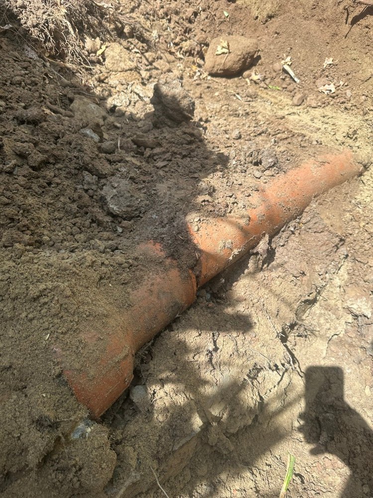 Old corroded sewer pipe uncovered during excavation