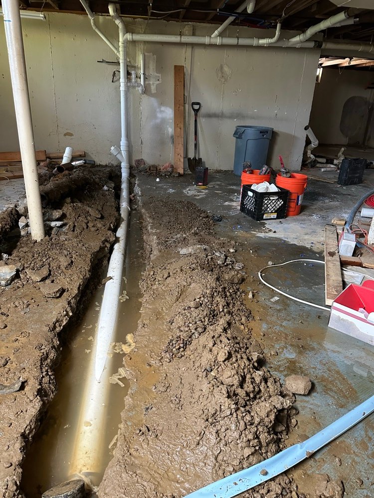 Sump pump drain line installation in basement